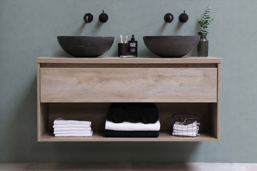 white and black ceramic bowl on brown wooden shelf