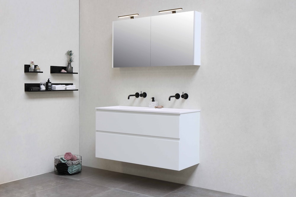 white wooden kitchen cabinet with black and white ceramic mugs on top