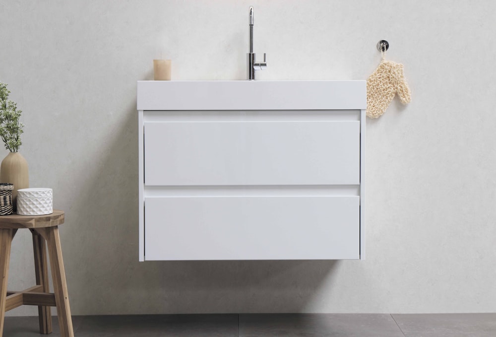 white wooden cabinet on white ceramic tiles