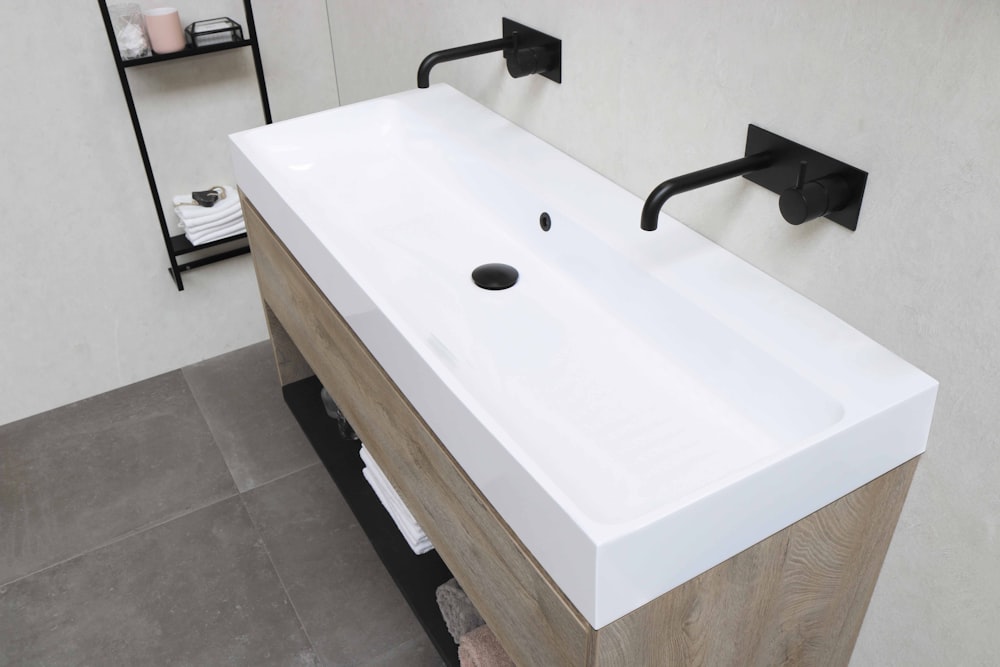 white ceramic sink with stainless steel faucet