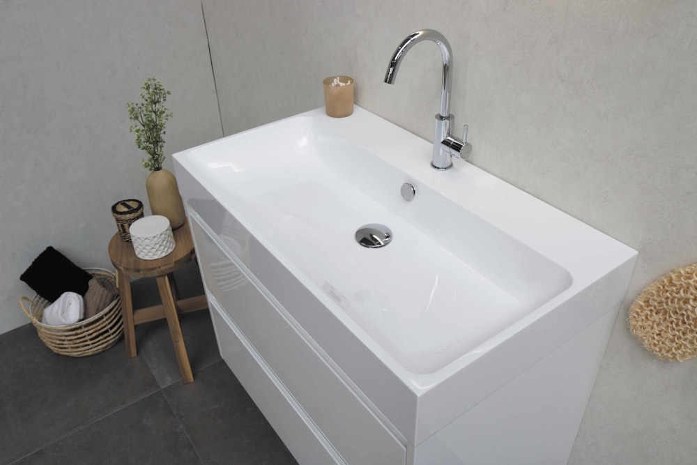 white ceramic sink with stainless steel faucet