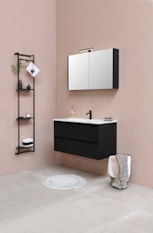 A cozy bathroom corner featuring a sleek floating vanity with a soft memory foam contour mat beneath.