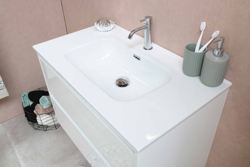 white ceramic sink with stainless steel faucet