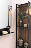 A minimalist soap dispenser made of glass on a wooden shelf.
