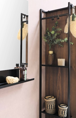 A collection of soap dispensers arranged on a bathroom shelf.