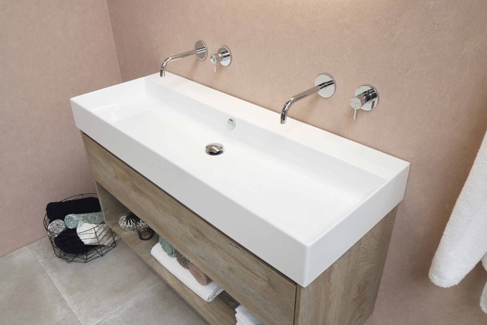 white ceramic sink with stainless steel faucet