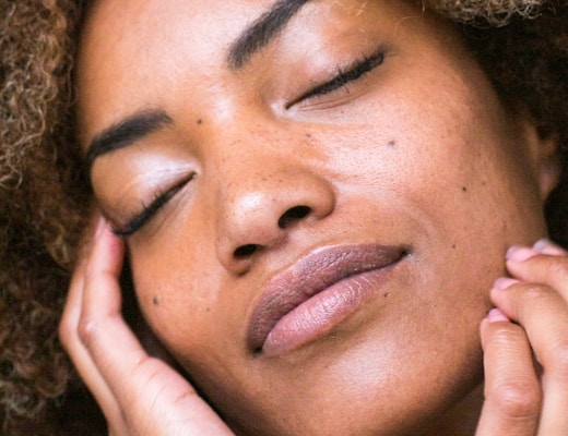 woman lying on brown textile