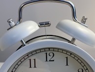 silver and white round analog clock