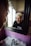 A person with blonde hair is standing in front of a mirror, displaying an intense, angry expression. The room features pink tiled walls, a white sink, and a silver faucet. The lighting suggests it is daytime, with natural light coming from a window beside the mirror.