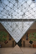 A serene event space under a biopyramid structure.