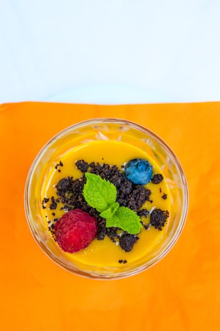 A person preparing a healthy dessert in a bright kitchen.