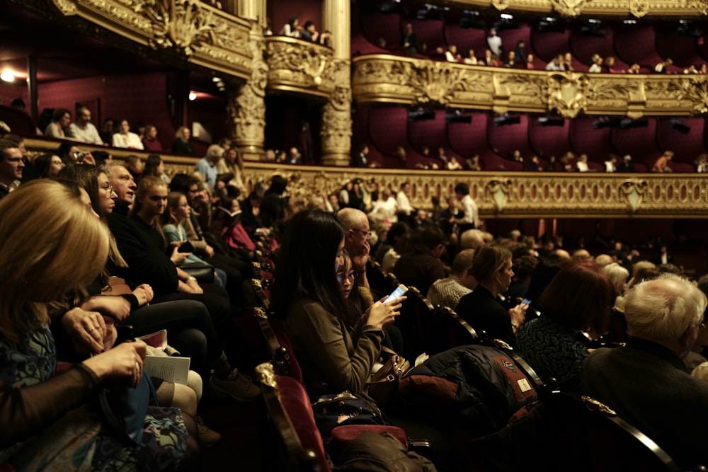 people sitting on red chairs