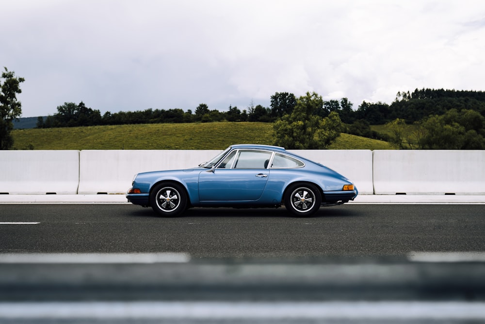 blue coupe on road during daytime