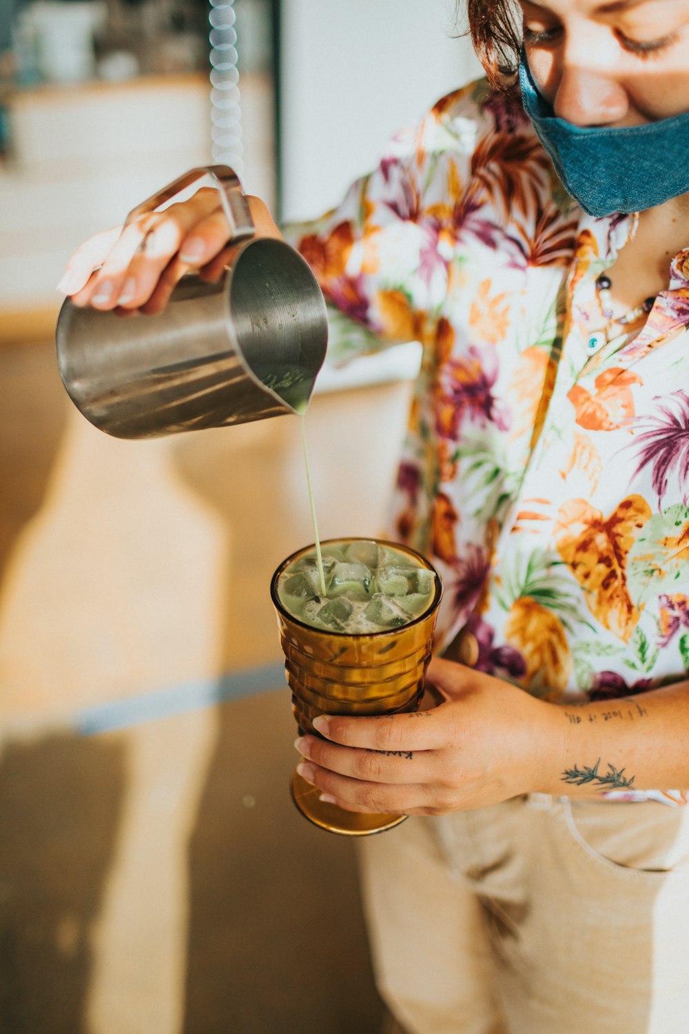 person pouring water on stainless steel cup