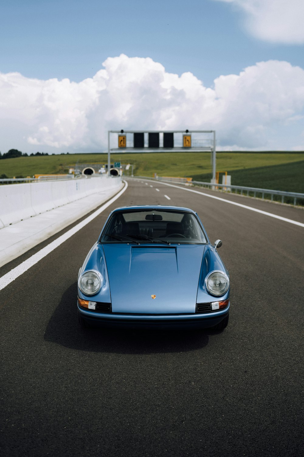 blue porsche 911 on road during daytime