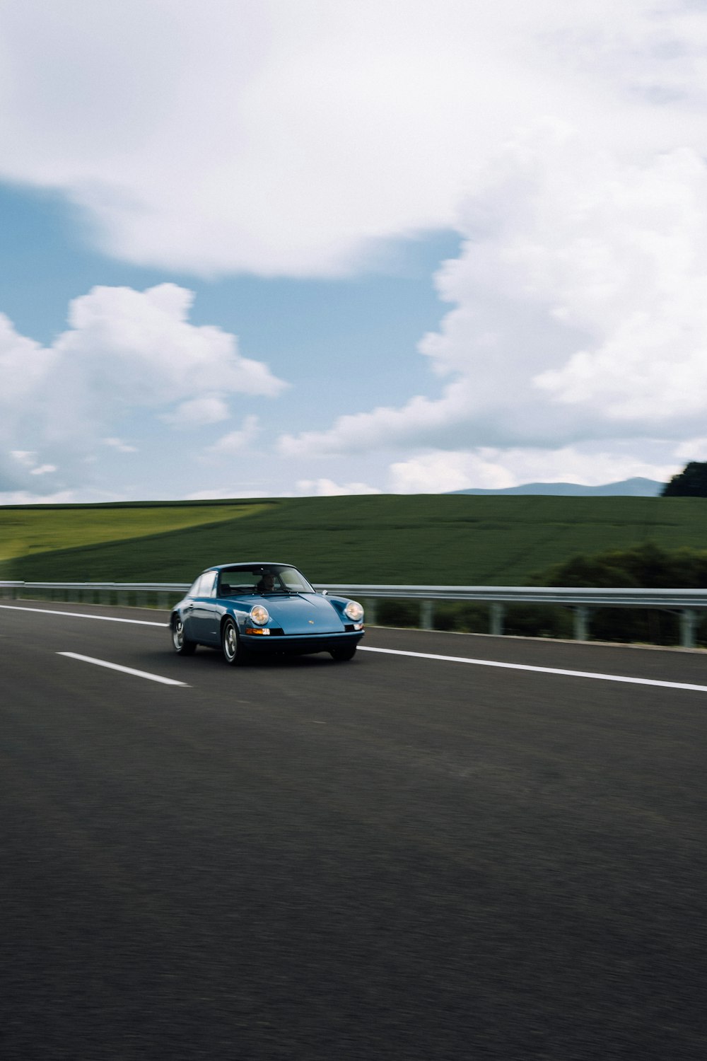 blue car on road during daytime