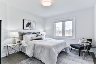 white bed linen on bed