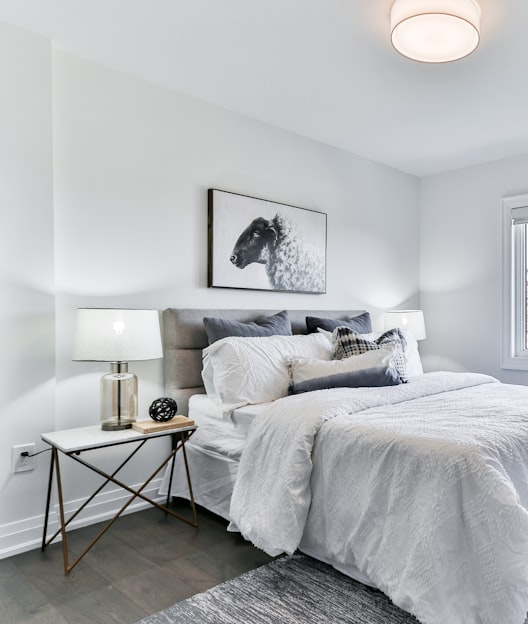 white bed linen on bed