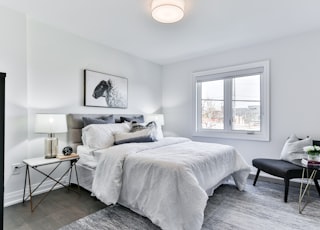 white bed linen on bed