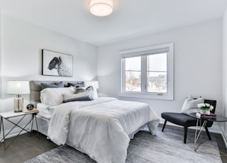 white bed linen on bed