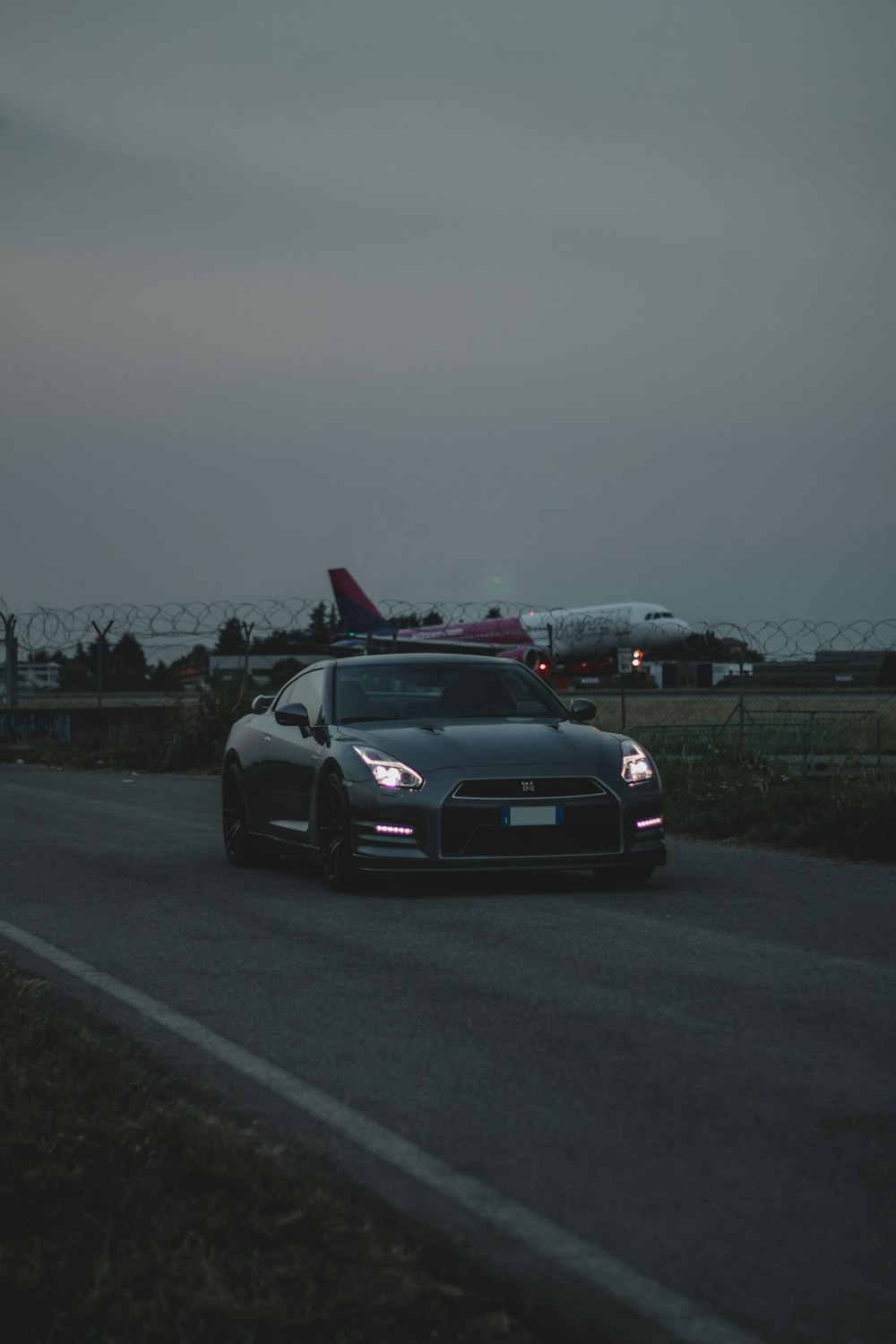 black car on gray asphalt road