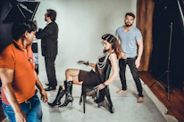 Close-up of a model receiving professional coaching on posture and expression.