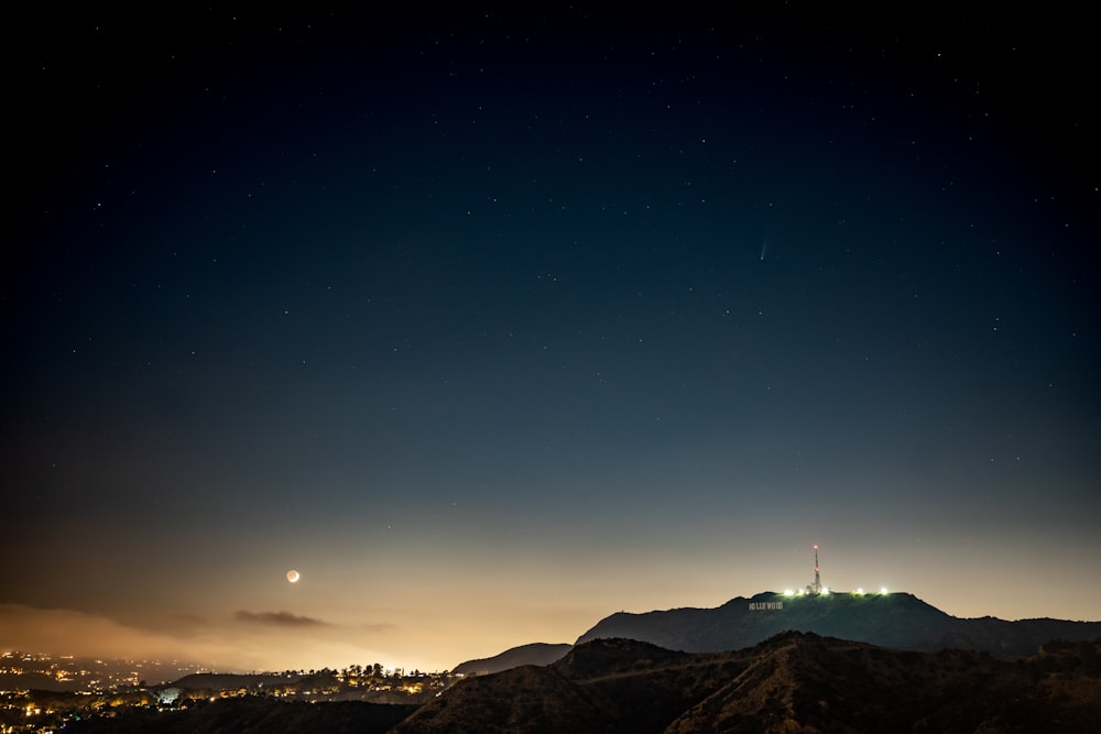 silhouette of mountain during night time