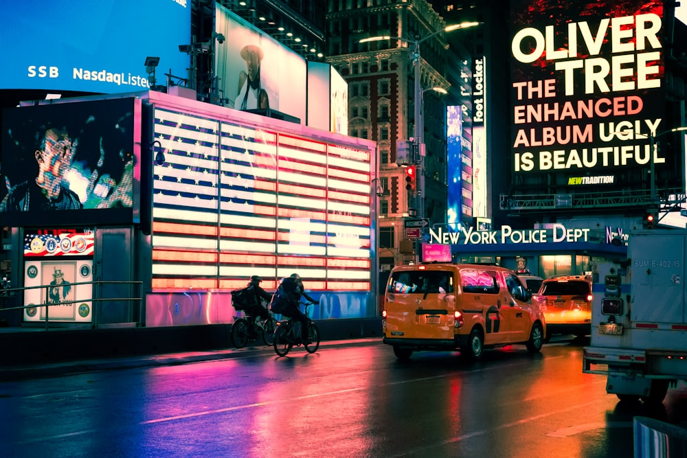 yellow taxi cab on street during night time