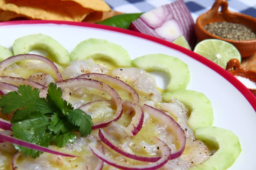 sliced cucumber on white ceramic plate, AGUACHILE DE CAMARON