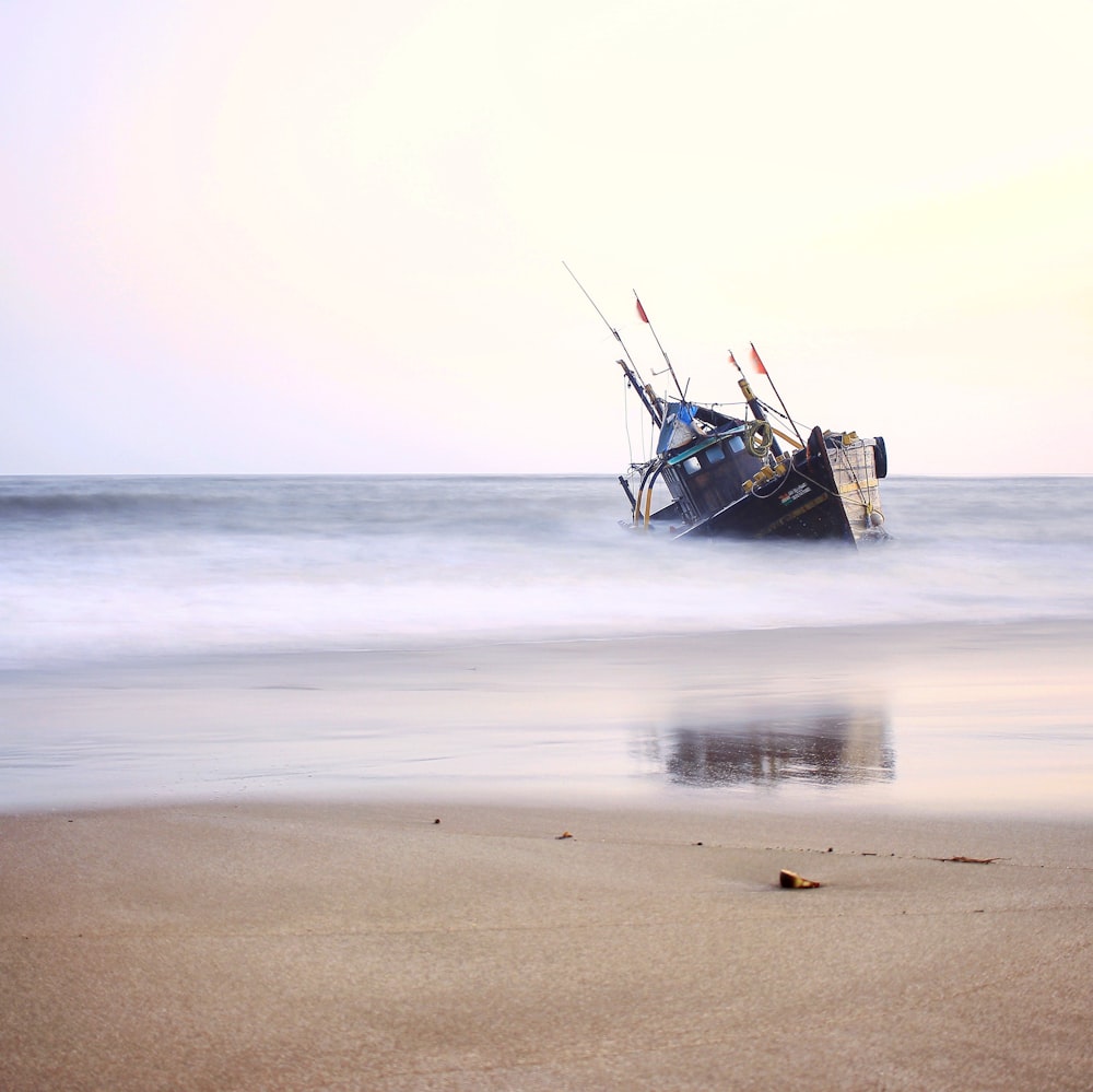 brown boat on beach during daytime