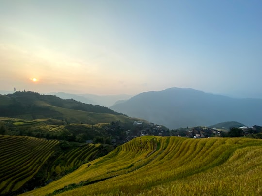 green grass field under blue sky during daytime in Guangxi China