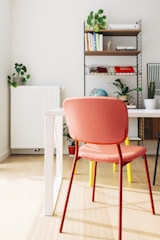 red and white chair beside brown wooden table