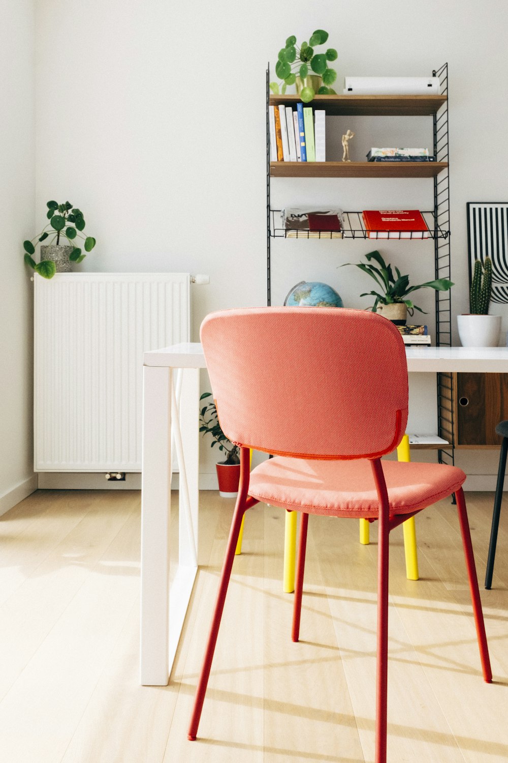 red and white chair beside brown wooden table