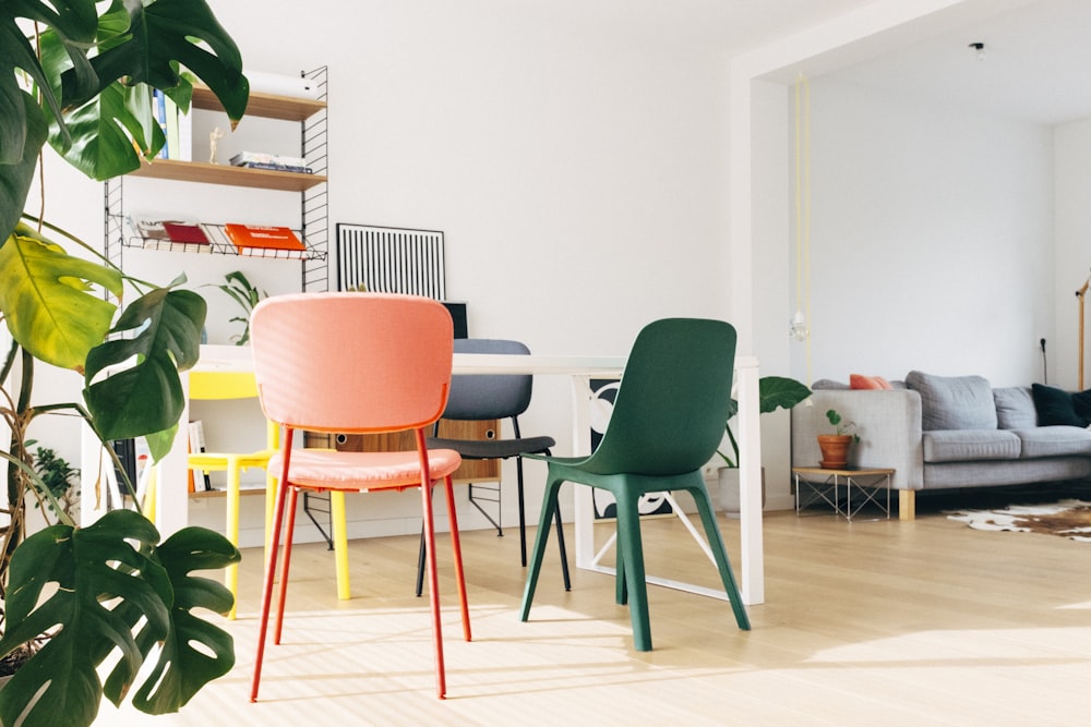 green and white chair beside white table