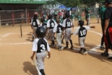 group of men playing baseball during daytime
