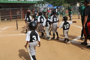 group of men playing baseball during daytime