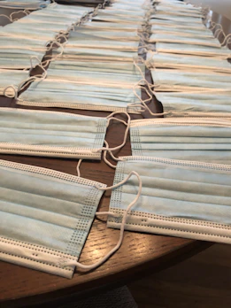 Rows of disposable hygienic wear hanging in a bright medical supply room.