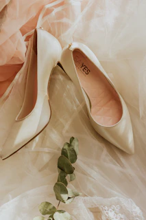 pair of white peep toe pumps