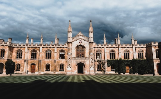 brown concrete building under cloudy sky during daytime in Corpus Christi College, Cambridge United Kingdom