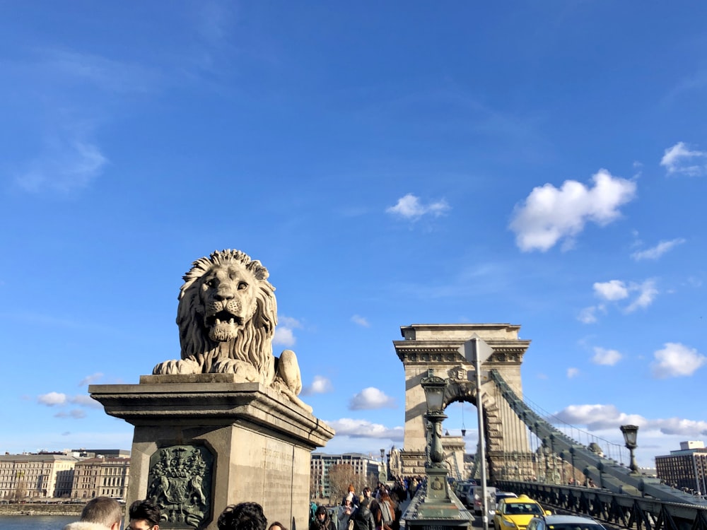 people walking on bridge under blue sky during daytime