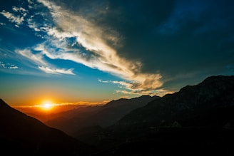 silhouette of mountains under blue sky during daytime