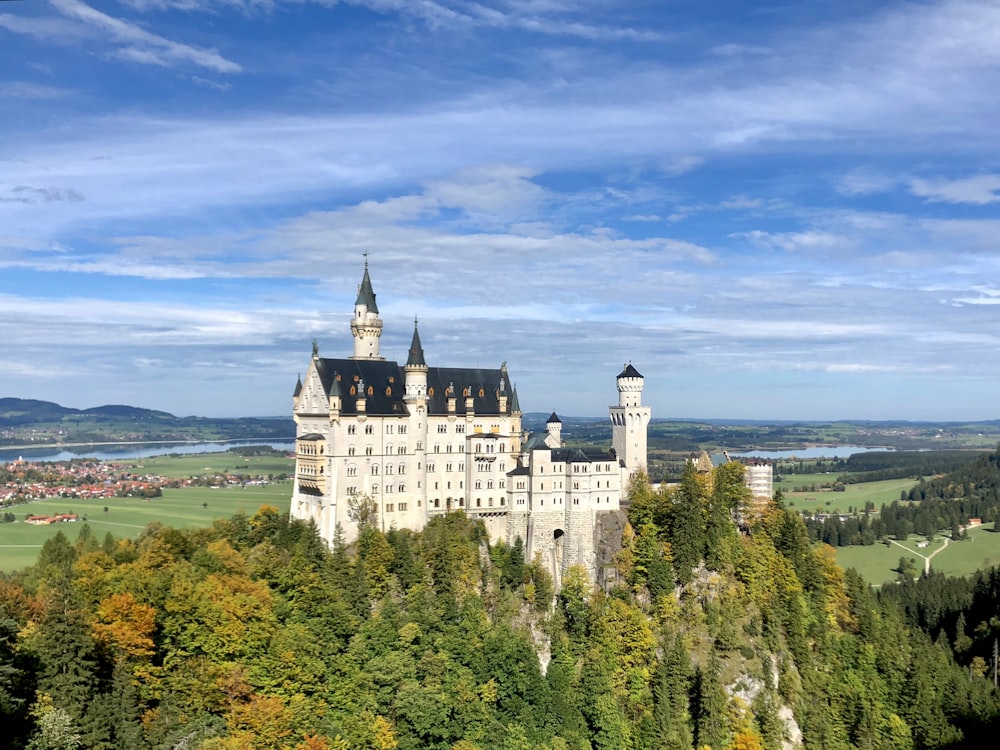 white concrete castle on top of hill during daytime