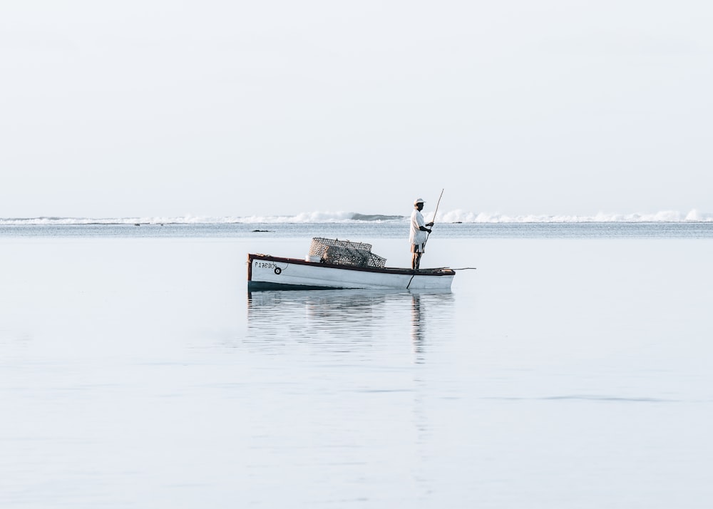 man in boat on sea during daytime