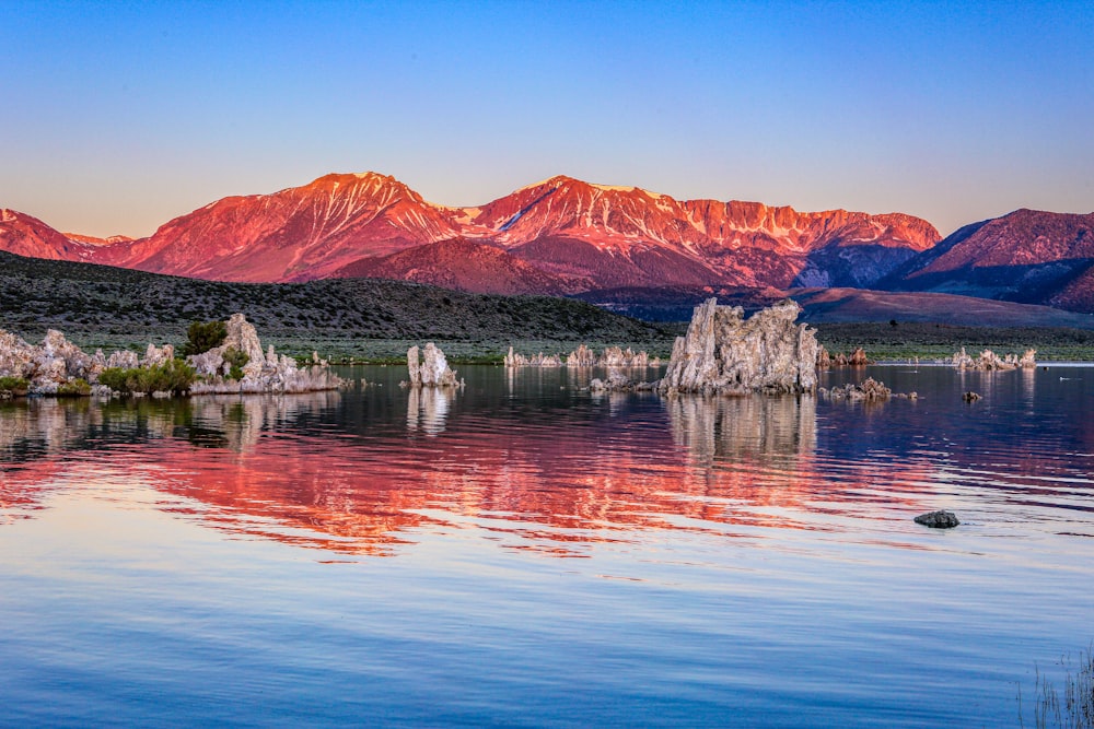 brown mountain near body of water during daytime