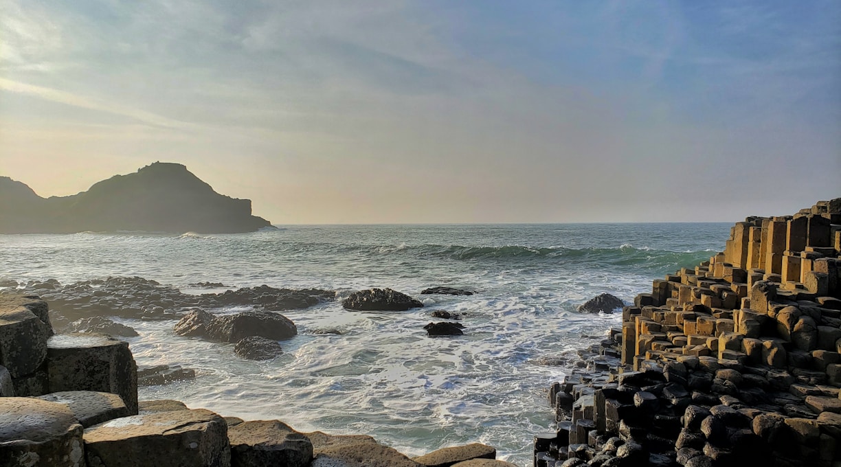 brown rocks on sea shore during daytime