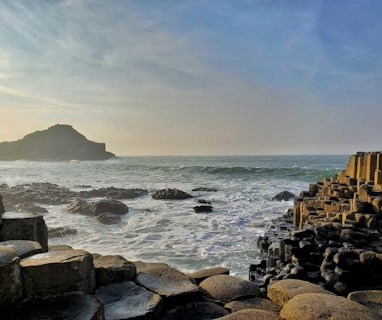 brown rocks on sea shore during daytime