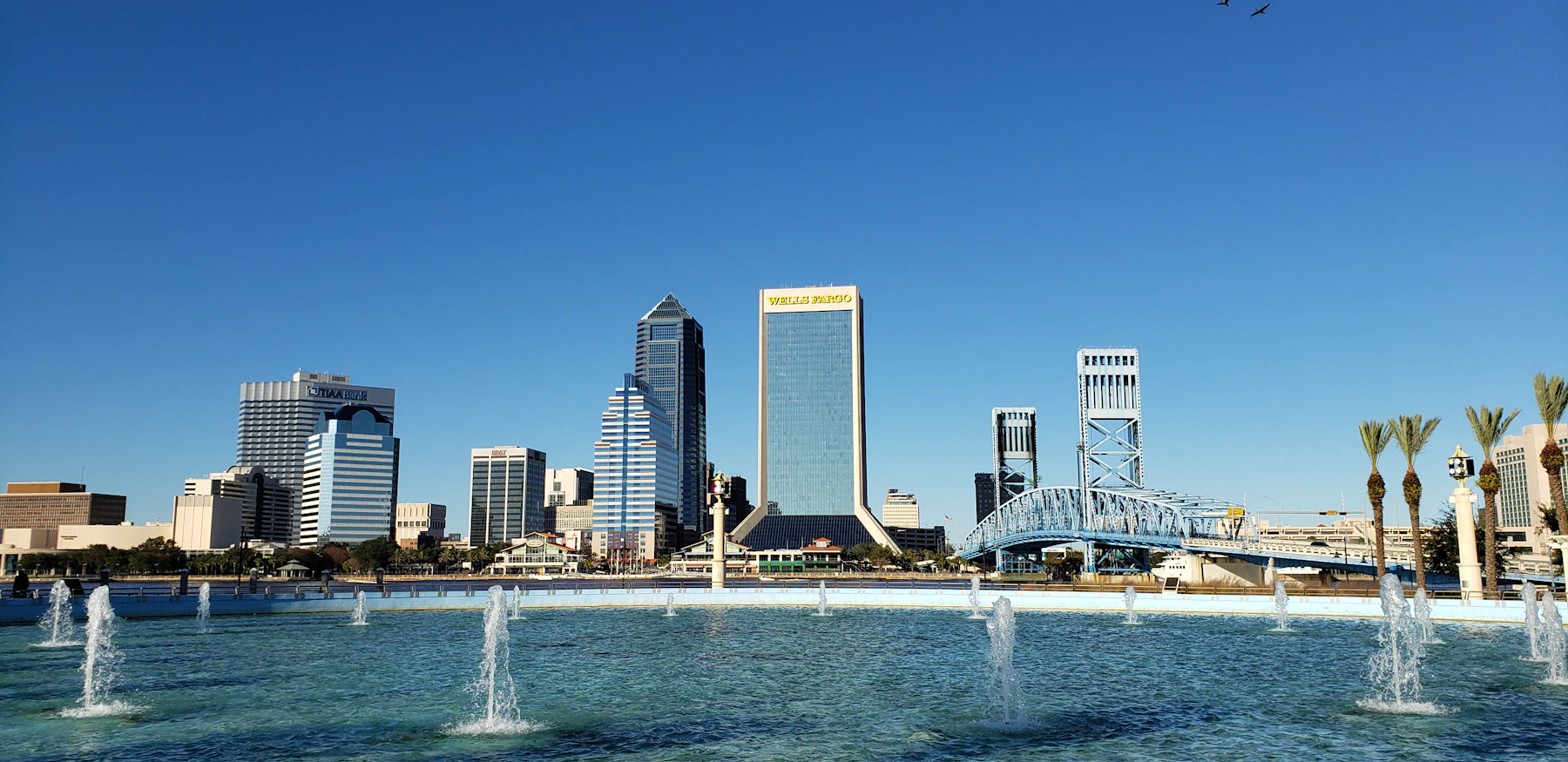 Jacksonville waterfront beneath a blue sky