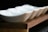 A close-up of various stylish bowls displayed on a wooden table.