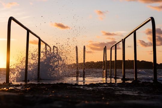 black metal railings on body of water during daytime in Varberg Sweden