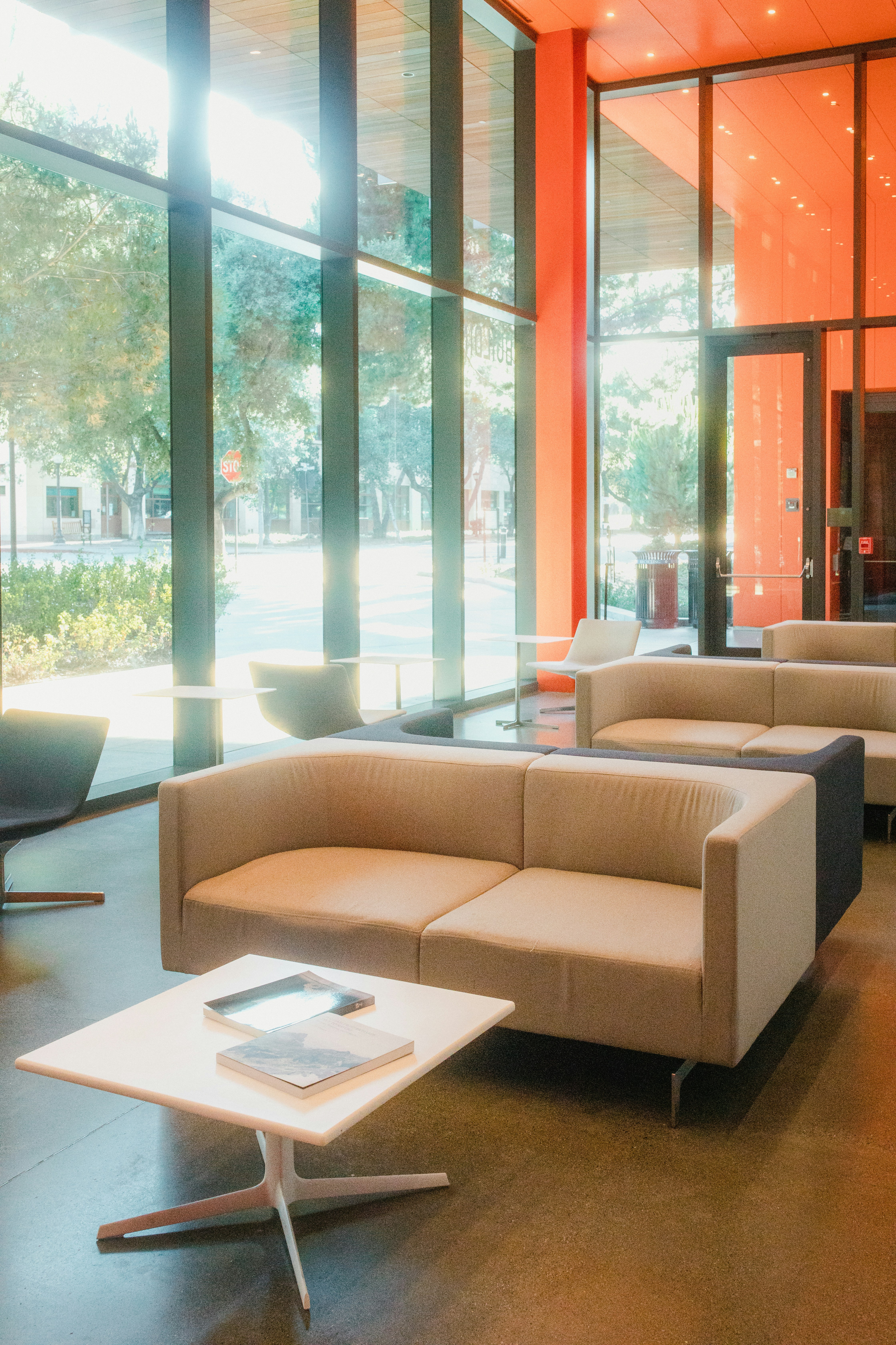 brown sectional couch near glass window